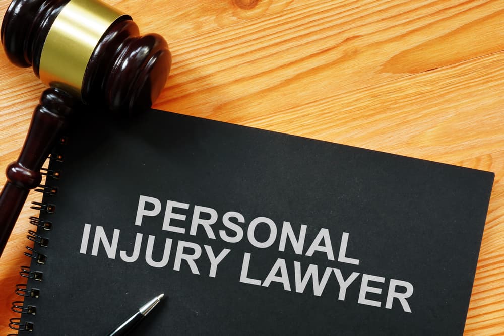 A conceptual photo showing printed text "personal injury lawyer" could represent the idea of seeking legal assistance for injuries caused by accidents or negligence. 