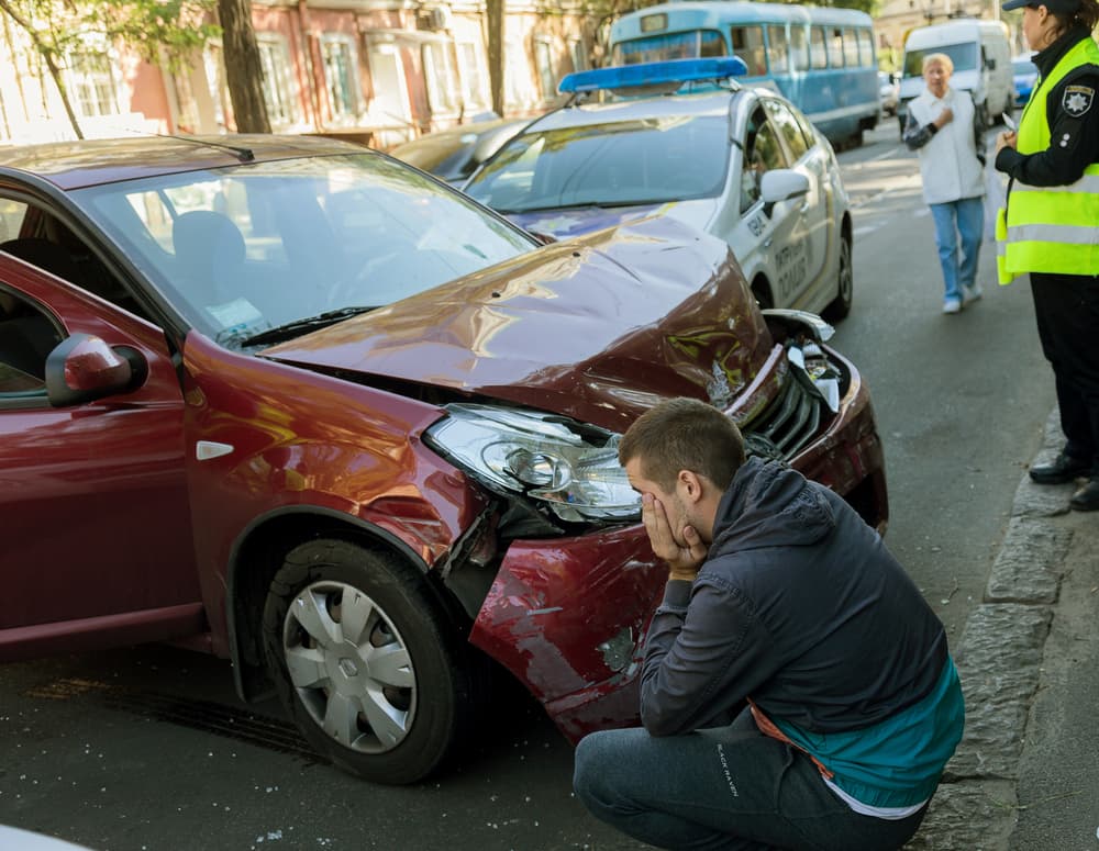 Highway car accident causing traffic jam and damaged cars after collision in the city. Road congestion ensues.