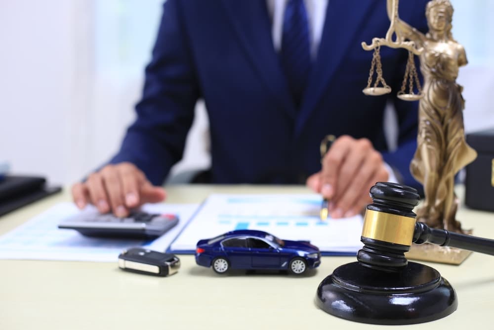 Judge's gavel and lawyer with businessman in a suit working on legal documents, symbolizing law, advice, and justice.