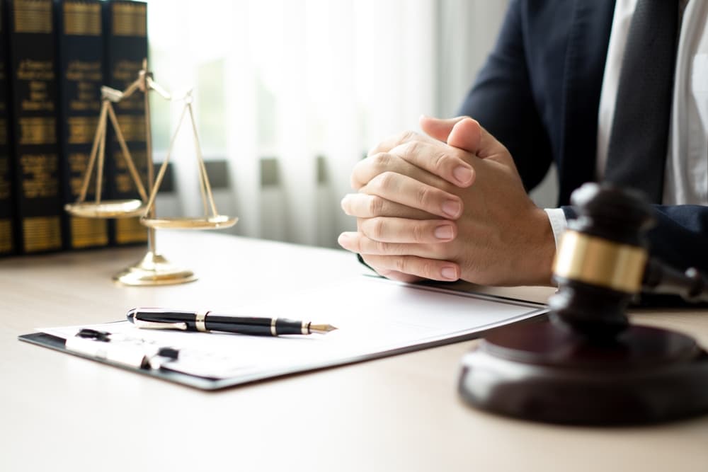 Lawyers in their office meticulously reviewing judicial documents to gather crucial information and build a strong legal strategy for their client's case.