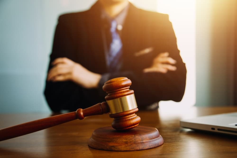 Male lawyer or judge consulting with a client during a team meeting, representing law and legal services