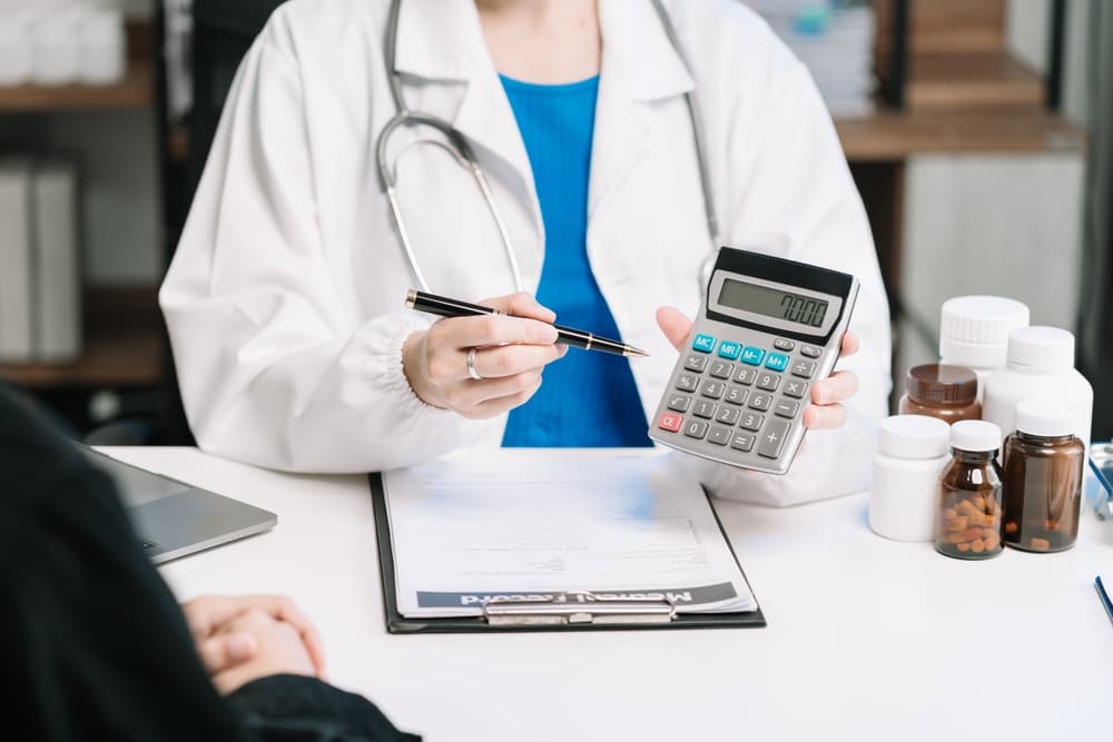 Medical professionals calculate service fees using a healthcare cost calculator, emphasizing cost-saving strategies in health insurance and medication expenses.