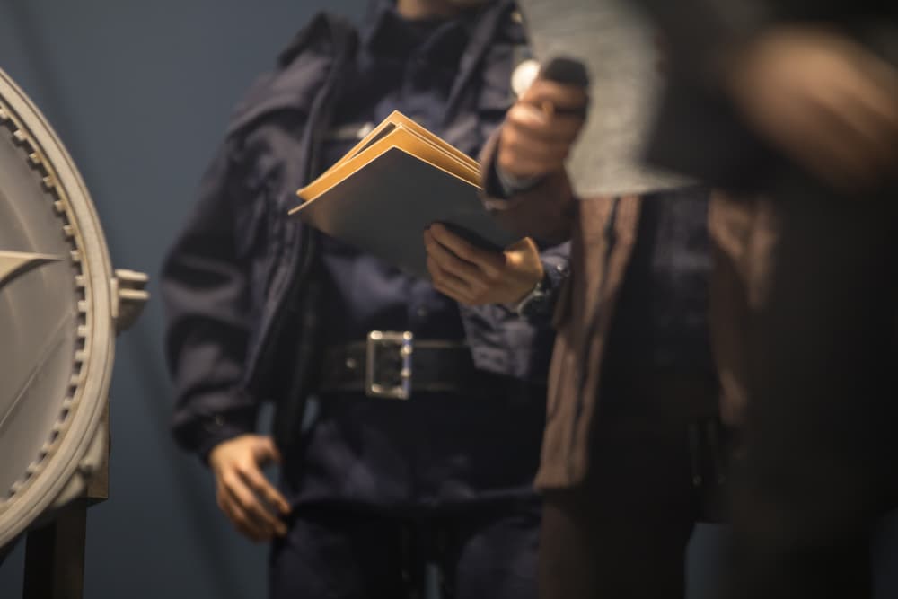 Policeman is reviewing files and documents